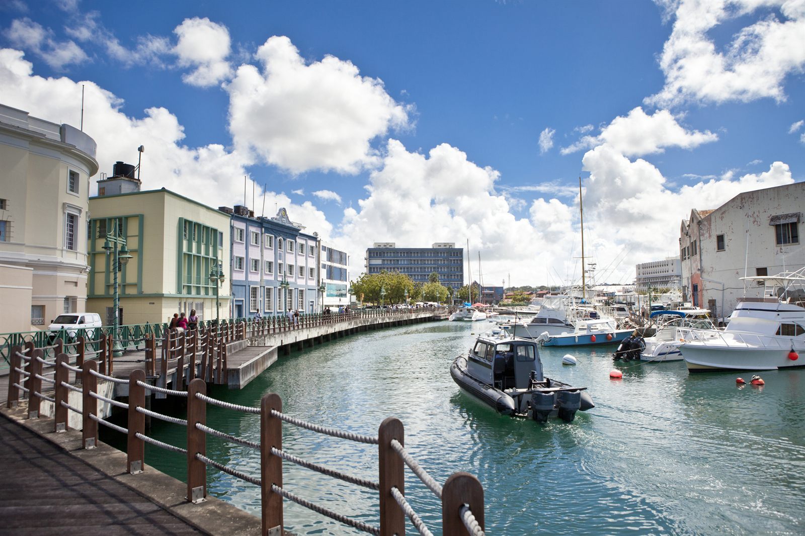 Waterfront promenade and small boats in a colorful harbor town