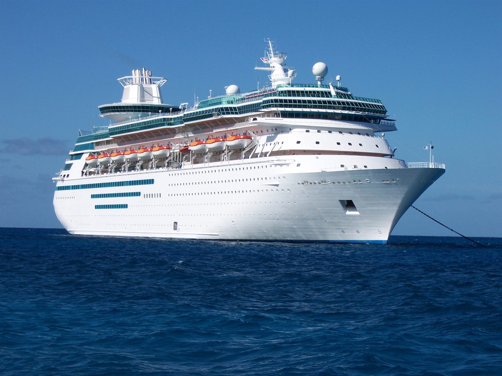 White cruise ship sailing on a deep blue sea